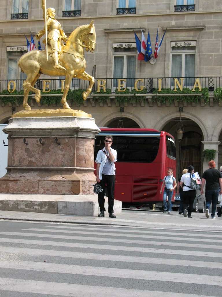 Mark Wihak stands holding a Bolex camera outside the Hotel Regina in Paris.  Photo by Wanda Schmöckel